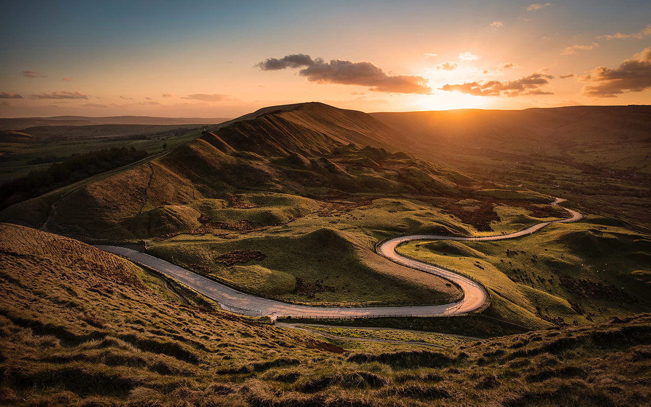 Sunset over mountains and road