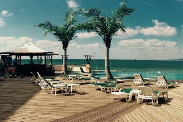 View of the ocean and palmtrees from a beach resort