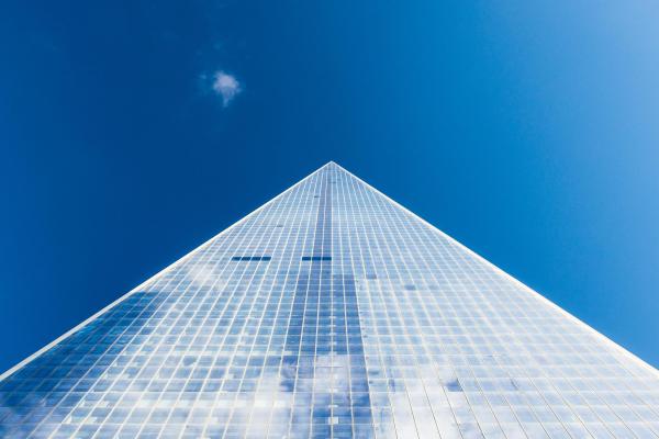 Looking up at a glass building and sky